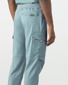 Java Tapered Cargo Pants offer a classic fit with a tastefully tapered leg, providing you with the perfect balance of comfort and a sleek, contemporary look. Stay organized and keep your essentials within reach with two front pockets, two side pockets, and a secure back pocket equipped with a reliable zipper closure. - Tapered cargo pants - Classic fit with tapered leg - Inseam 29" - 2 front pockets - 2 side pockets - 1 back pocket with zipper - Ribbed waistband and back cuff Functional Tapered Leg Cargo Pants, Functional Blue Cotton Bottoms, Blue Tapered Leg Pants With Side Pockets, Blue Utility Pants With Tapered Leg, Utility Cargo Pants With Tapered Leg, Functional Straight Leg Work Pants With Pockets, Blue Straight Leg Work Pants With Cargo Pockets, Functional Blue Bottoms With Hip Pockets, Tapered Cargo Pants With Hip Pockets