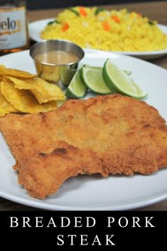 a plate with fish, chips and rice on it