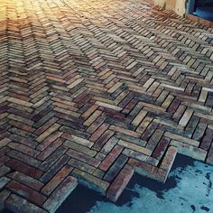 a skateboarder is doing tricks on a brick walkway