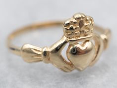 Claddagh rings are a traditional token of affection, with the crown, heart, and hands representing loyalty, love, and friendship. This piece would make a special promise ring or wedding band!Metal: 14K Yellow GoldWidth of Band: 9.7 mmHeight off Finger: 2.2 mmRing Size: 6 Claddagh Ring Wedding, Gold Claddagh Ring, Claddagh Ring, Band Metal, Love And Friendship, Irish Jewelry, Claddagh Rings, Irish Wedding, Unique Engagement