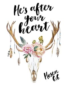 a deer skull with flowers on it and the words he's after your heart