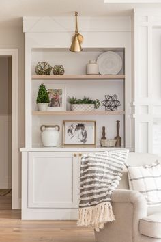 a living room filled with furniture and decor on top of a hard wood floored floor