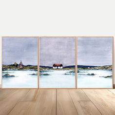 three paintings on a wall with wood flooring in front of them, one is a house and the other has a barn