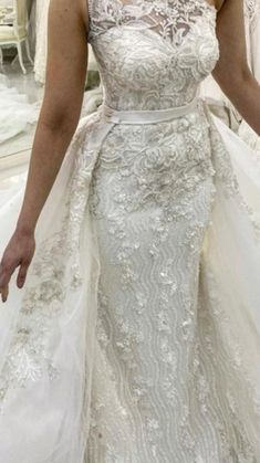 a woman in a white wedding dress is looking at the camera