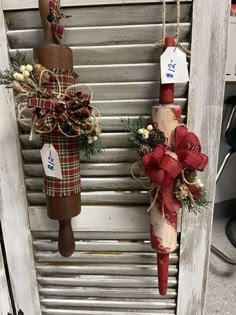 two christmas decorations hanging on the side of a wooden door with price tags attached to them