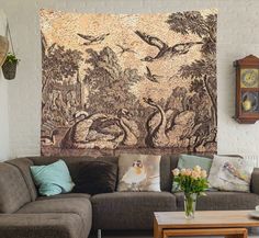 a living room filled with furniture and a tapestry on the wall