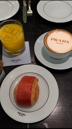 a table topped with plates filled with food next to glasses of orange juice and coffee