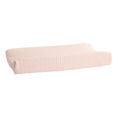 a pink bed pillow sitting on top of a white wall