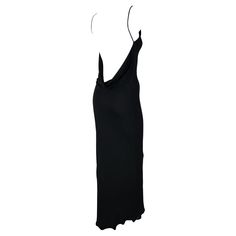 This backless black gown by Israeli-American designer Yigal Azrouël, dating back to the late 1990s, epitomizes versatility. Whether for a formal occasion or a more casual event, this chic gown fits the bill. It boasts a high, wide neckline and a captivating exposed back adorned with a delicate cowl detail at the upper rear. Crafted from slinky and stretchy fabric, it ensures both comfort and allure. Approximate measurements: Size - 1US Bust: 28 - 38" Waist: 26 - 32" Hips: 32 - 40" Shoulder to he Evening Maxi Dress With Bias Cut And Low Back, Black Maxi Dress With Cowl Back For Evening, Black Low-back Maxi Dress For Evening, Black Low Back Maxi Dress For Evening, Black Backless Evening Dress With Bias Cut, Backless Black Slip Dress For Gala, Black Bias Cut Backless Evening Dress, Black Backless Evening Dress With Low Back, Black Backless Low Back Evening Dress