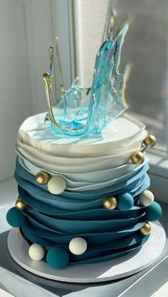 a blue and white cake sitting on top of a table