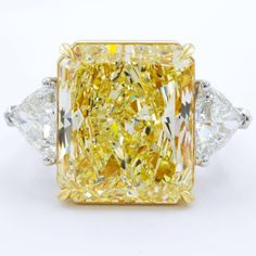 This immaculate Fancy Yellow Elongated Radiant & Trillions 3 Stone Diamond Ring is one of a kind. The center stone is a rare GIA certified Elongated 5.50 carat fancy yellow canary elongated radiant cut diamond accented by trillion-cut diamonds. The combination of extraordinary shape, color, and cut make this ring a one of a kind piece. Metal : 18K Gold, Platinum/18KY Setting Type : Prong Total Carat : 6.20 Carats Type : Natural Diamond Shape : Radiant Cut Carat Weight : 5.50 Ct. (GIA Certified) Canary Diamond Ring, Canary Yellow Diamonds, Radiant Diamond Rings, Radiant Cut Diamond Ring, Canary Diamond, Yellow Diamonds Engagement, Cushion Diamond Ring, Yellow Diamond Engagement Ring, Cushion Cut Diamond Ring