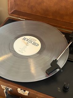 an old record player with its turntable open