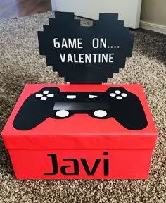 a game on valentine box with a video game controller cut out in the middle and a sign that says, game on valentine