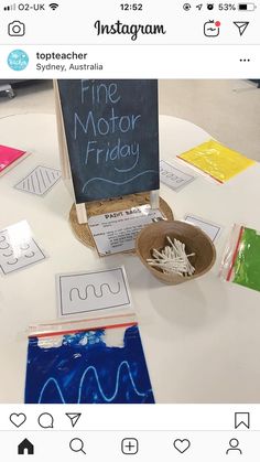 a white table topped with lots of different types of paper and crafting supplies on top of it