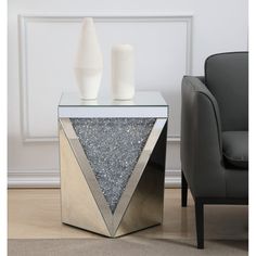 Glamourize your home and let your rooms sparkle with this polygon shaped end table. Panels of triangles are decorated with glittering gray crystals embellishing clear glass. These sparkling gray crystals both compliment and complement the polished clear beveled mirror panels that border and decorate the rest of the decor. Its shining and reflective beauty will add modern elegance and contemporary style to any space. Adorn it with your favorite objectscaptivating art pieces, beautiful floral arra Art Deco Lights, Gray Crystals, Mirrored End Table, Clear Mirror, Classic Chandeliers, Mirror Panels, Chandelier Table Lamp, Table Setting Decor, Art Deco Chandelier