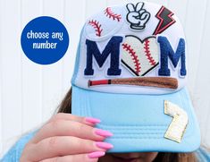 Our custom baseball mom hat for women, are stylish trucker hats with patches. This personalized baseball hat, featuring number patch(es) to represent your favorite player. It is the perfect sports mom gift and an ideal hat for a baseball mom. ☀️ DETAILS: -customize your hat as much or as little as you want! -choose your hat color -choose from one of our two premade patch designs -substitute the number patch with your own number(s) -OR you can completely customize your own hat from start to finish -patches are adhered by heat press (not sewn) -polyester and cotton materials ☀️ HAT SIZE: -crown height: 4 inches -brim length: 3 inches -hat circumference: approx. 22 to 25 inches -adjustable buckle ☀️PREMADE DESIGNS: -patches will be arranged the same way as in the sample -choose your hat color Baseball Season Snapback Trucker Hat With Letter Embroidery, Mother's Day Baseball Cap With Letter Print, Personalized Snapback Trucker Hat For Baseball Season, Adjustable Trucker Hat With Letter Embroidery For Baseball Season, Personalized Baseball Cap With Curved Bill For Baseball Season, Personalized Curved Bill Baseball Cap For Baseball Season, Baseball Season Trucker Hat With Letter Patch, Personalized Snapback Hat For Baseball Season, Personalized Snapback Cap For Baseball Season