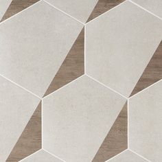 a white and brown tiled floor with hexagonal shapes