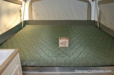 a mattress in the back of a camper with a tag on it's side