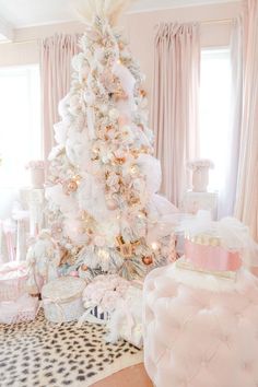 a white christmas tree with pink and gold decorations