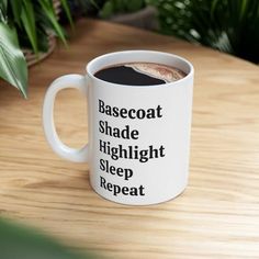 a white coffee mug with the words basecoat shade, highlight and sleep repeat on it