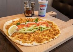 a pizza sitting on top of a wooden cutting board