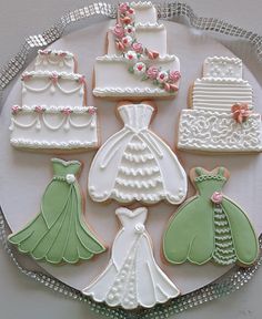 decorated cookies in the shape of wedding gowns and dresses