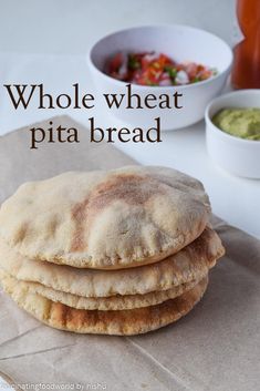 three pita breads stacked on top of each other next to a bowl of salsa