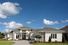 a large house with lots of windows and landscaping