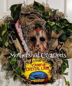 a wreath with a scary mask on it that says, motleyshed creations come to camp at crystal lake