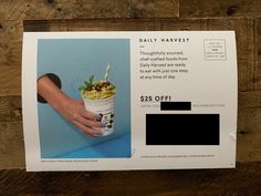 a person holding a cup of soup in their left hand and an ad for the daily harvest