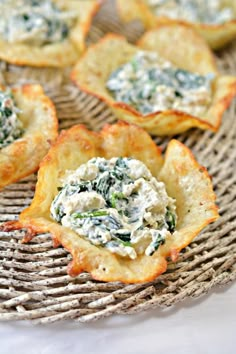 small appetizers with spinach and cheese on a wicker tray, ready to be eaten