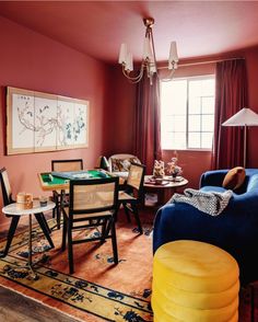 a living room filled with furniture and a painting on the wall