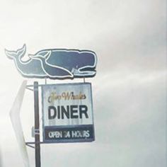 a sign for a restaurant with a whale on it's head and the word diner written in large letters