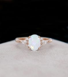 Oval Opal Ring, Dainty Opal Ring, Statement Rings Simulated Diamond Ring, Gold Opal Ring, Opal Ring, Jewellery, Delicate Ring, Stacking Ring ♠ Stone Details ➵ Opal Stone: 7x5mm (0.45Ct) ➵ Side Stone Weight: 0.10 Ct ➵ Gemstone: Opal ➵ Stone Color (White) ➵ Stone Luster: Excellent ➵ Stone Make: High Quality ➵ Center Stone Shape: Oval ➵ Metal Change(10k/14k/18k White/Yellow/Rose Gold) ➵ Handmade item I accept custom making order. please contact me if you need this service. All the jewelry in my sto Promise Ring Opal, Simple Opal Wedding Rings, Opal Wedding Ring Set White Gold, White Crystal Promise Toe Ring, White Crystal Toe Ring For Promise, Adjustable Oval Opal Ring For Wedding, Wedding Ring Opal, Opal Ring Simple, Opal Birthstone Ring