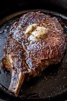 a piece of meat is being cooked in a skillet