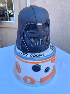 a star wars themed cake with a darth vader helmet on top