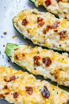 cheesy stuffed zucchini boats on a baking sheet