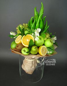 a vase filled with green and yellow fruit