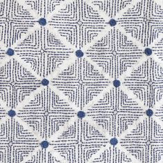 an upholstered fabric with blue and white squares on the top, as well as dots