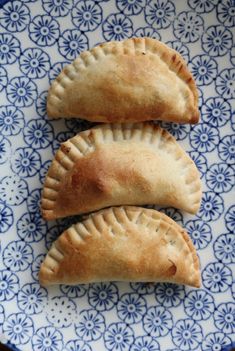 three pastries on a blue and white plate