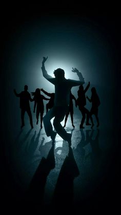 silhouettes of people dancing in the dark