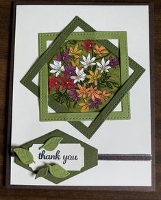 a thank you card with flowers on it and a tag that says thank you in the center