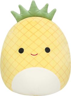 a yellow pineapple pillow with black eyes and a green leaf on it's head