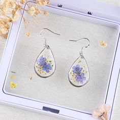 925 Sterling Silver Forget Me Not Flower Earrings | Real Pressed Flower Earrings | Handmade Floral Earrings for Women | Dangle Drop Earrings | Non-allergenic 🌸【Size】: 1 * 1.6 inches 🌸Introducing our exquisite 925 Sterling Silver Forget Me Not Flower Earrings. These stunning and unique floral earrings are meticulously handcrafted with love, adding a touch of natural beauty to your jewelry collection. Made from real pressed forget-me-not flowers, these dangle drop earrings beautifully display the delicate petals and vibrant blue hues of the forget-me-not blossoms. 🌸Highlights: 1. Handmade with Love: Each pair of these earrings is crafted by skilled artisans with the utmost care, ensuring a truly one-of-a-kind piece of jewelry. 2. Real Pressed Flowers: We select and preserve genuine forget Silver Teardrop Flower Earrings For Pierced Ears, Silver Teardrop Flower Earrings, Handmade Silver Flower Earrings For Mother's Day, Sterling Silver Teardrop Flower Earrings, Mother's Day Silver Handmade Flower Earrings, Silver Sterling Flower Earrings With Pressed Flowers, Silver Dangle Earrings With Birth Flower, Silver Sterling Silver Earrings With Pressed Flowers, Mother's Day Sterling Silver Flower Earrings