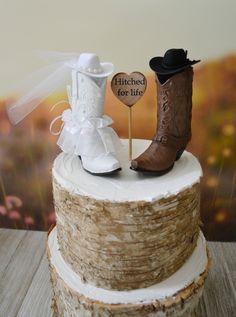 a wedding cake with cowboy boots and a sign