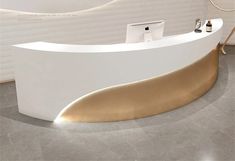 a white and gold reception desk in an office