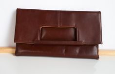 Simply elegant vintage 2 in 1 made in Montreal Canada signed ''Chic'' reddish-brown leather women purse convertible clutch or handbag with one external pocket which closes with a zipper. The interior linen is in brown faux suede. 10 x 10 x 0.5 inches when worn as a handbag and 10 x 5-3/4 x 7/8 inches when worn as a clutch. As shown in the picture, this purse can be worn as clutch or as handbag Good condition with very clean interior and minor surface scratches due to storage and minor discoloration of the brown color on the corners on the bottom -  sold as is -return not accepted. Very solid built - this purse was worn a couple of times only. To make this a smooth and pleasant transaction experience for everyone, all buyers need to read and understand the description, the terms of sale , t Vintage Brown Rectangular Wallets For Daily Use, Vintage Brown Rectangular Wallet For Daily Use, Rectangular Vintage Brown Wallet For Daily Use, Brown Soft Leather Satchel Clutch, Vintage Brown Satchel Clutch, Office Clutch With Fold Over Clasp, Retro Clutch For Daily Use, Leather Clutch With Magnetic Closure, Brown Leather Clutch With Detachable Strap