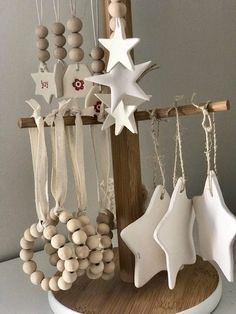 some ornaments are hanging from a wooden pole