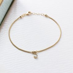 This dainty 14k gold solitaire bracelet is a timeless piece, featuring a solid gold popcorn chain with a dangling zircon stone in a bezel setting. Perfect for women who value real gold jewelry, this bracelet offers both comfort and versatility.   The bracelet features a lobster clasp, allowing you to easily fasten and remove it without needing a third hand. You can wear and adjust it on your own without any help. In addition to the length of your choice, our bracelets come with a free 1 inch extension chain. This way, you can adjust the fit of your bracelet to your personal preference, whether you like it tight or a little looser. The bracelet is hallmarked "14K" and will be sent in a stylish box with express shipping. BRACELET DETAILS * Material: High Quality 14 carat solid gold * Gemston Gold Popcorn, Solitaire Bracelet, Bezel Bracelet, Real Gold Jewelry, Birthday Jewelry Gift, Gold Bracelet Chain, Dangle Charms, Bracelet For Women, Chain Link Bracelet