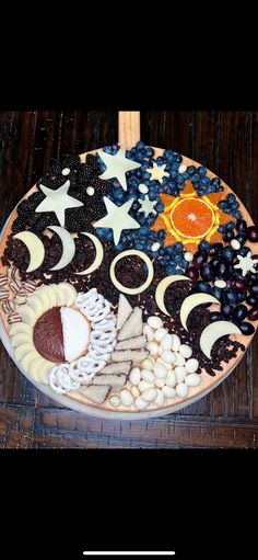 a platter filled with different types of food on top of a wooden table next to a knife